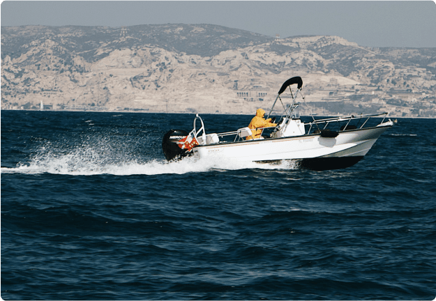 Speedboat cruising on choppy water near cliffs