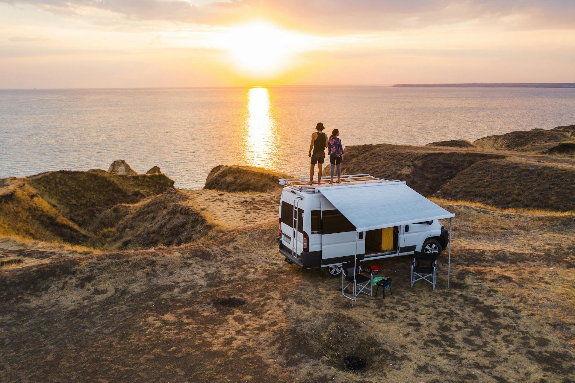 Couple by the beach on a self-built campervan