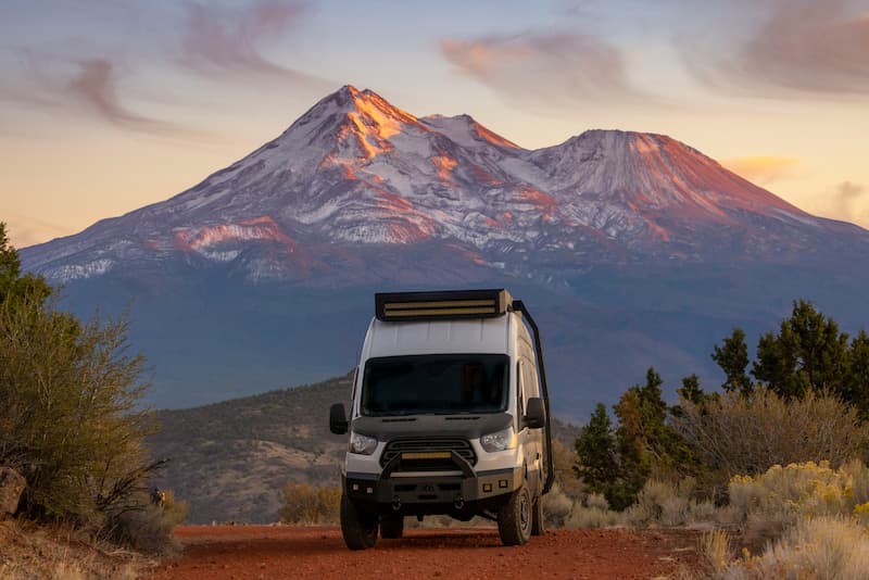 Rv with mountains in the background parked in a scenic location