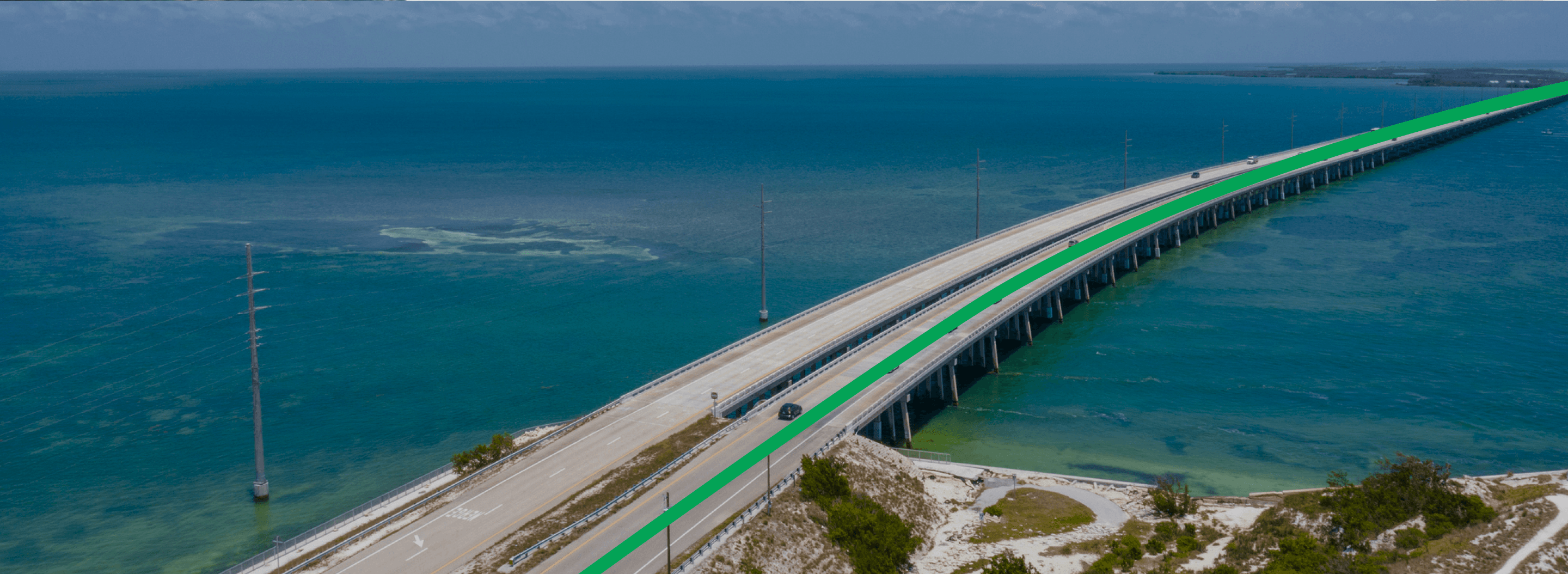 Winding mountain highway curves through rolling green hills at golden sunset, perfect scenic route for RV adventures